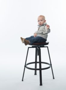 a child sitting on a high chair